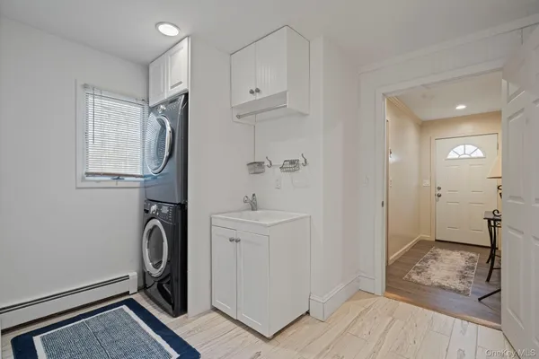 a view of a storage & utility room with closet dryer