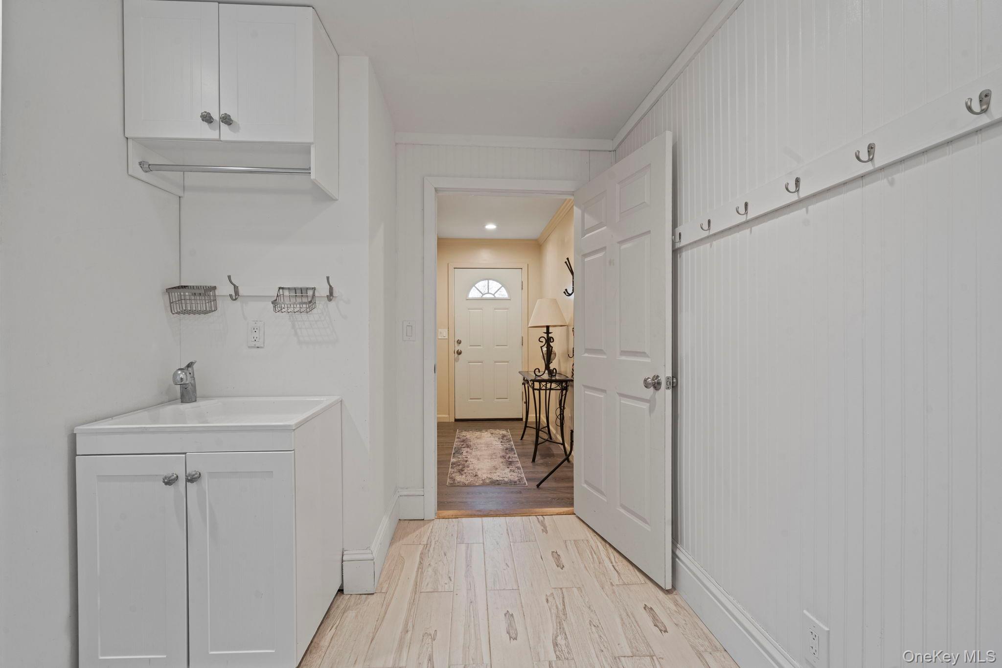 25 Cliff Road West Wading River, NY 11792 - Photo 21 of 35 a view of a hallway with wooden floor