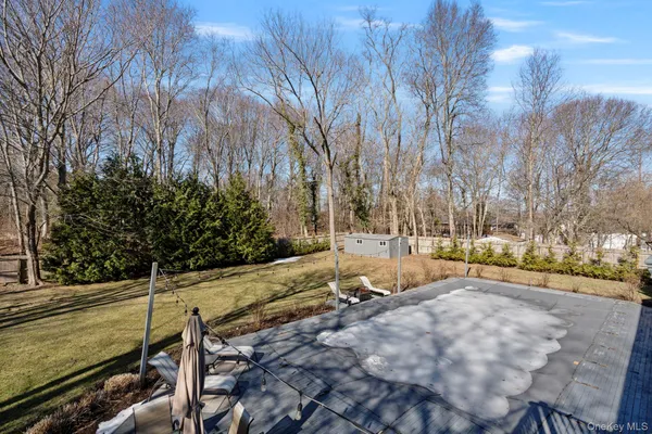 a view of a yard with wooden fence