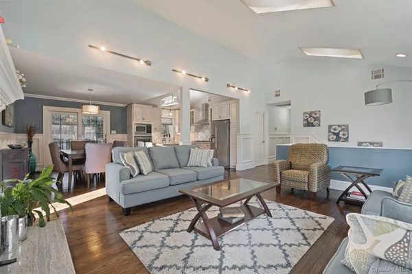 a living room with furniture wooden floor and a table