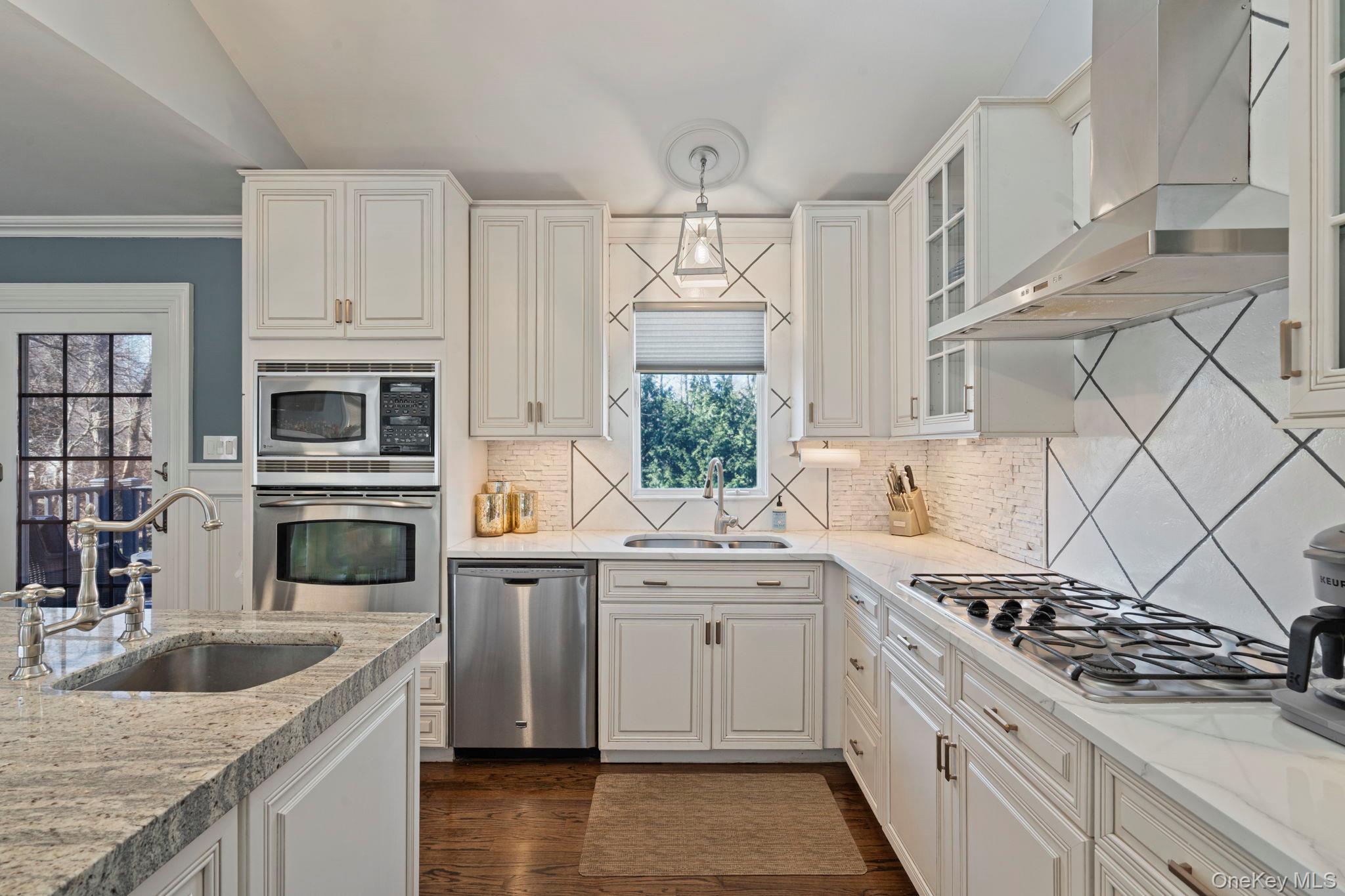 25 Cliff Road West Wading River, NY 11792 - Photo 8 of 35 a kitchen with stainless steel appliances granite countertop a sink stove and refrigerator