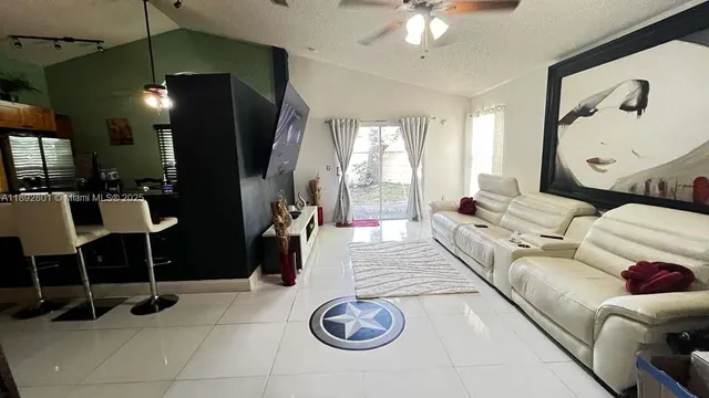 a living room with furniture a window and a chandelier