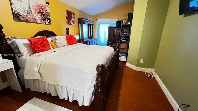 a bed sitting in a bedroom next to a small bathroom