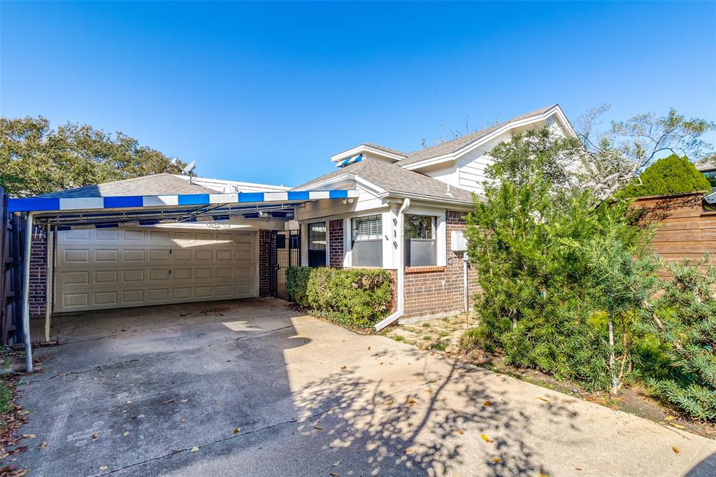 919 Liberty Court Dallas, TX 75204 - Photo 1 of 30 View of front of house with concrete driveway to covered carport and two car garage.