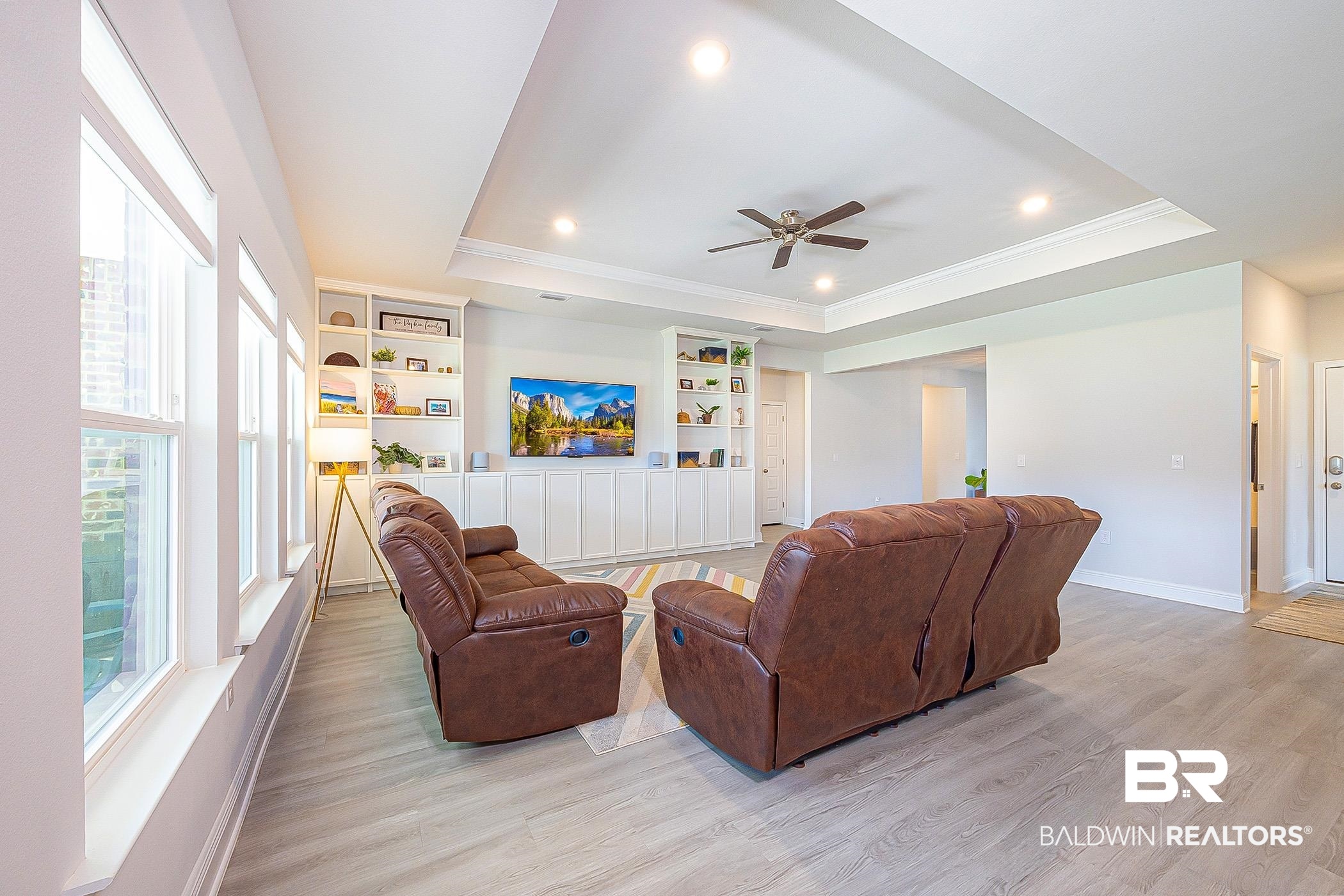 11044 Native Dancer Way Daphne, AL 36526 - Photo 8 of 67 Living room featuring a raised ceiling, hardwood / wood-style floors, and ceiling fan