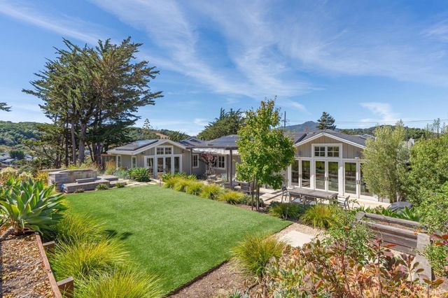 a front view of a house with a garden