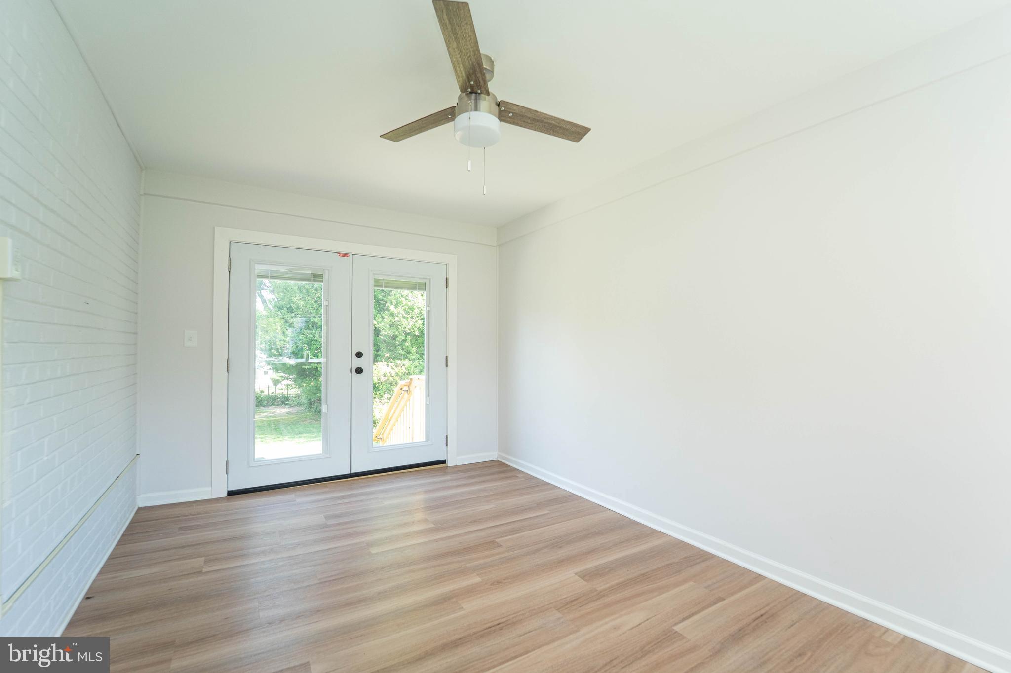 8909 Georgia Avenue Silver Spring, MD 20910 - Photo 14 of 47 an empty room with wooden floor and windows
