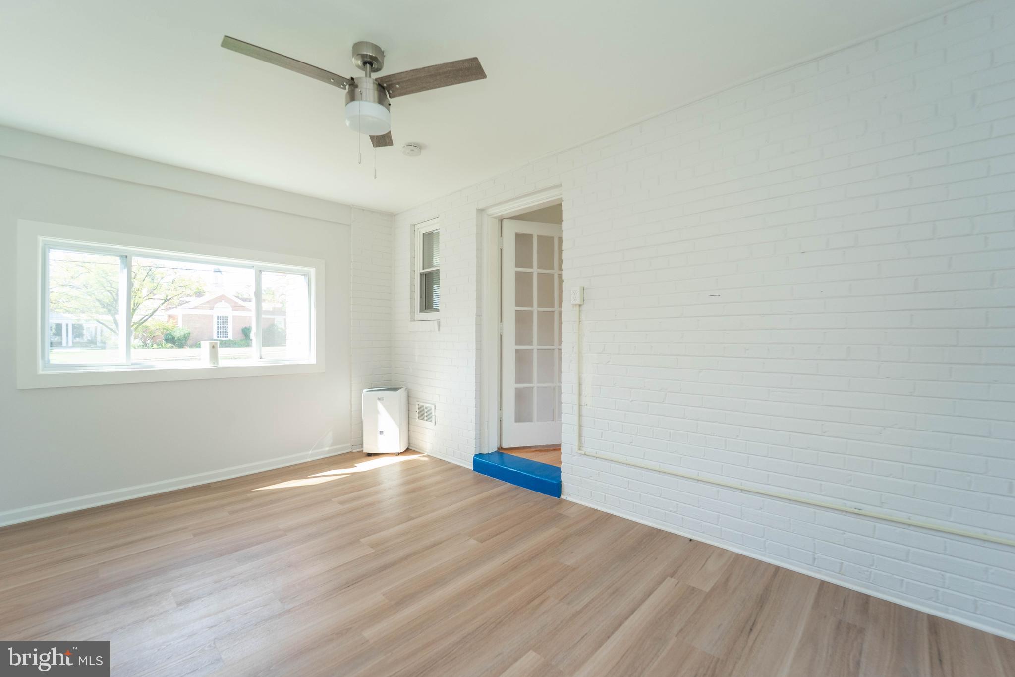 8909 Georgia Avenue Silver Spring, MD 20910 - Photo 16 of 47 a view of empty room with wooden floor and fan