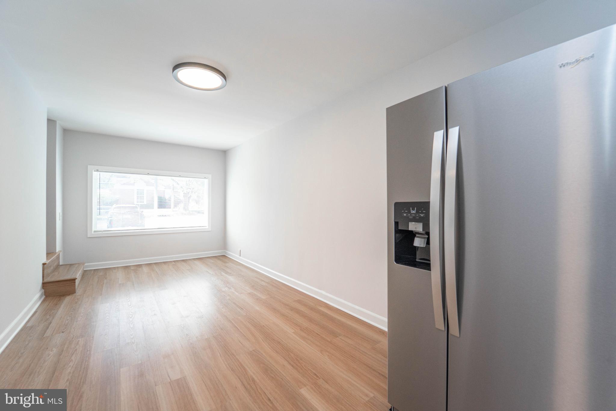 8909 Georgia Avenue Silver Spring, MD 20910 - Photo 22 of 47 a view of an empty room with wooden floor and a window