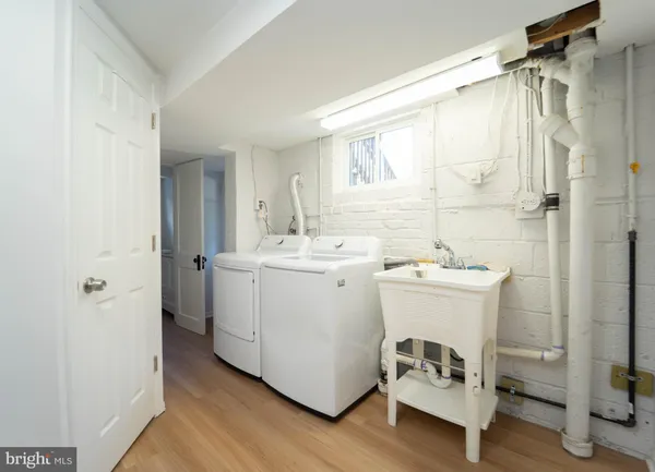 a utility room with cabinets washer and dryer