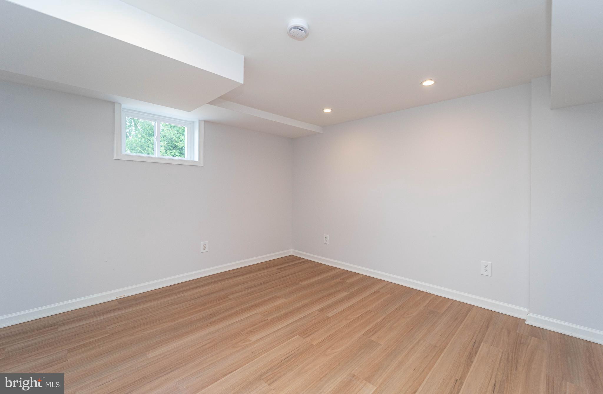 8909 Georgia Avenue Silver Spring, MD 20910 - Photo 33 of 47 an empty room with wooden floor and windows