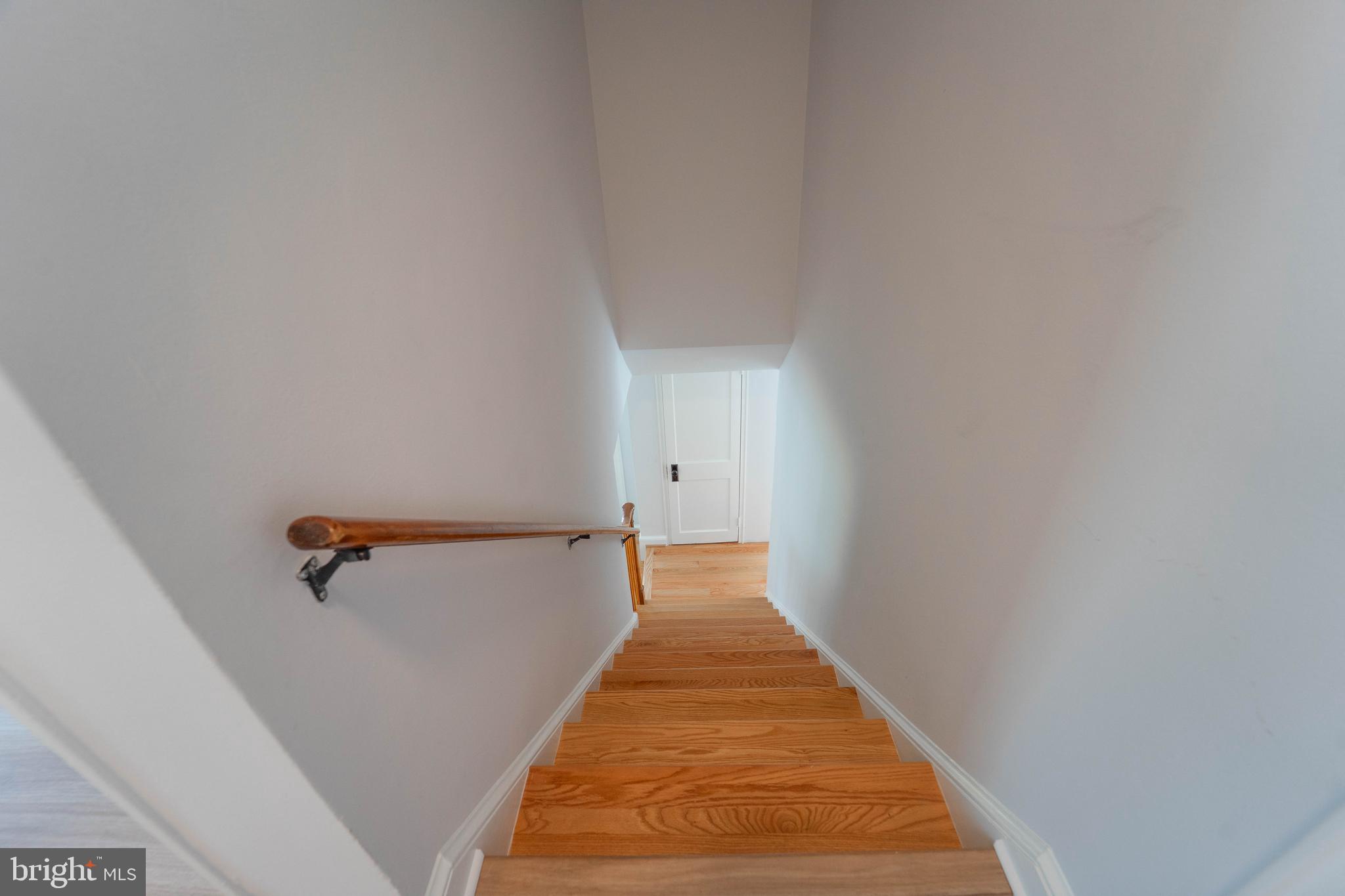 8909 Georgia Avenue Silver Spring, MD 20910 - Photo 36 of 47 a view of a hallway with wooden floor and a white wall