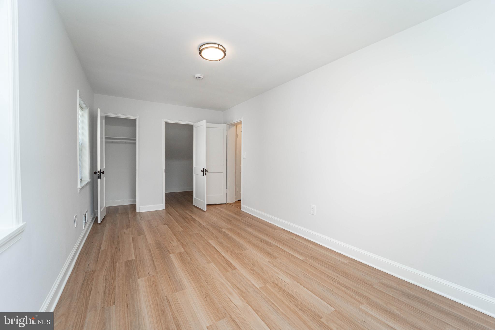 8909 Georgia Avenue Silver Spring, MD 20910 - Photo 38 of 47 a view of an empty room with wooden floor