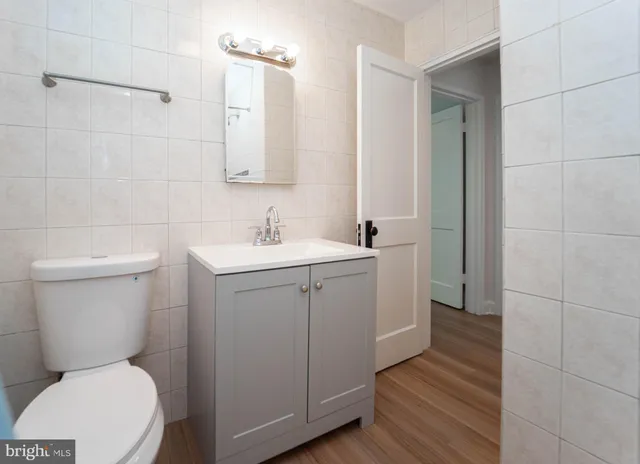 a bathroom with a toilet sink and mirror