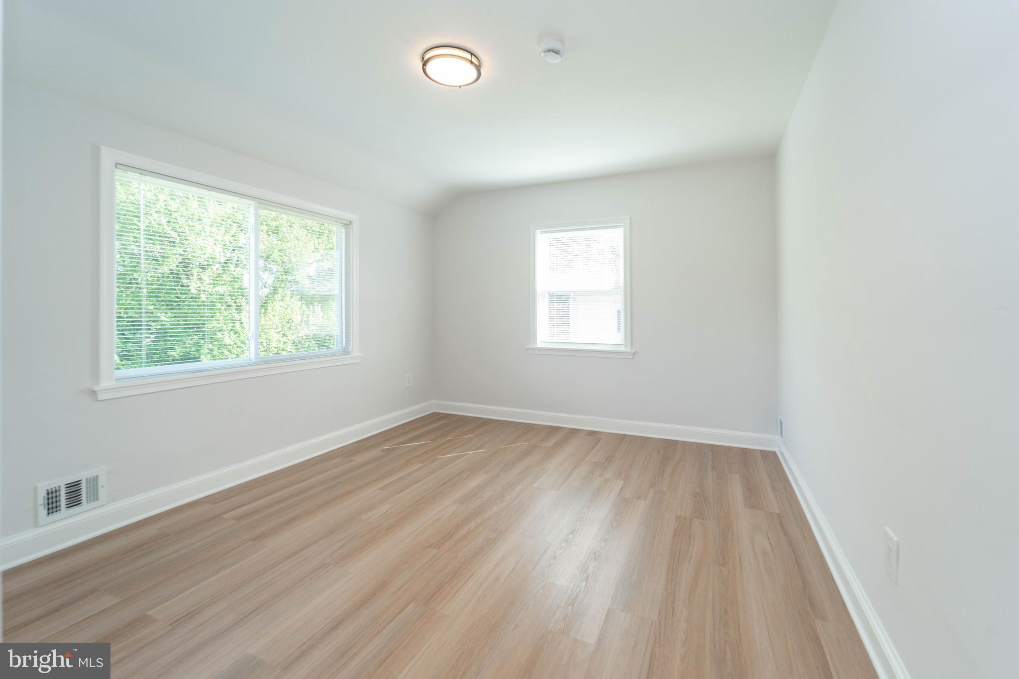 8909 Georgia Avenue Silver Spring, MD 20910 - Photo 42 of 47 an empty room with wooden floor and windows