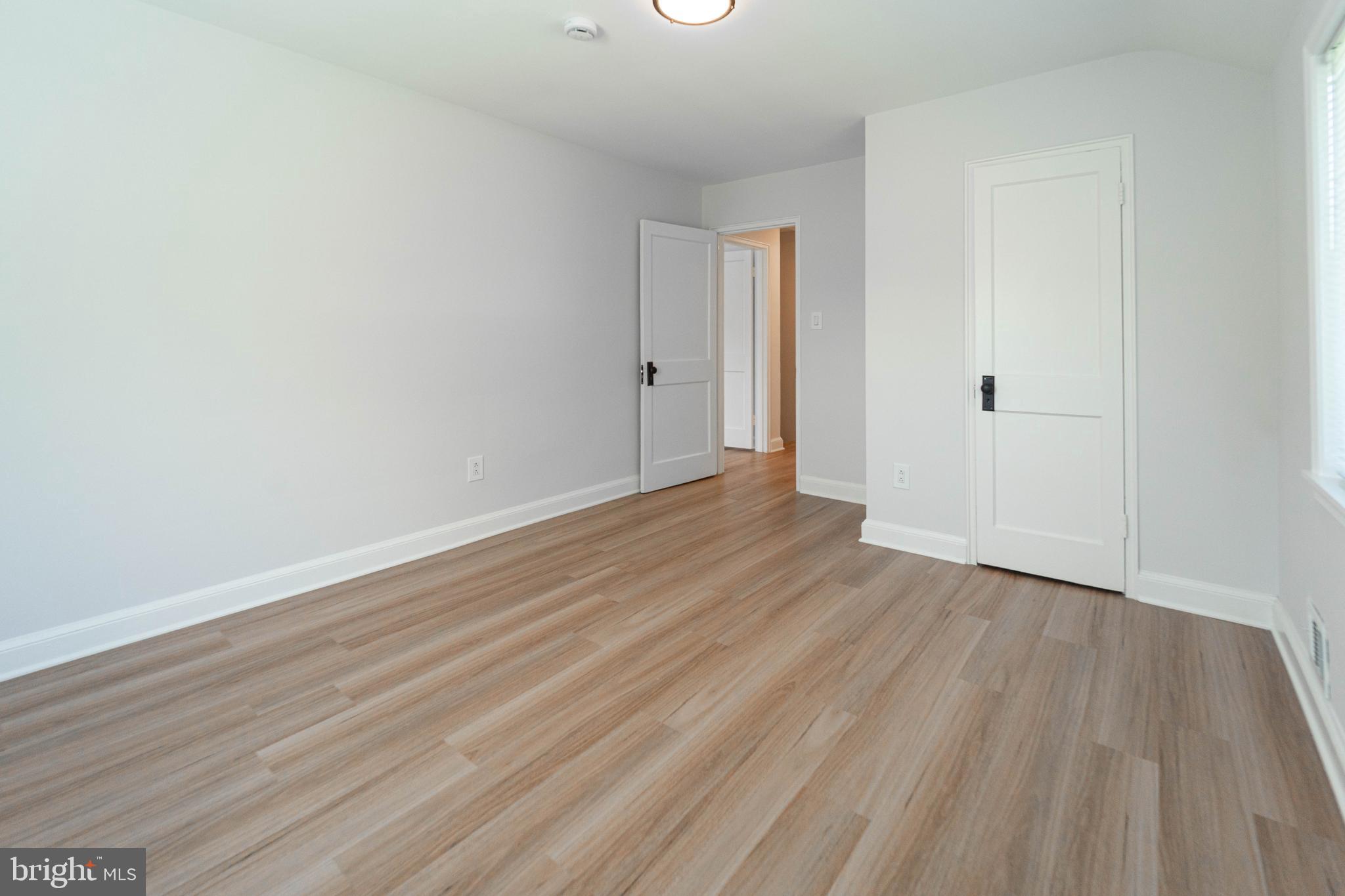 8909 Georgia Avenue Silver Spring, MD 20910 - Photo 44 of 47 a view of an empty room with wooden floor