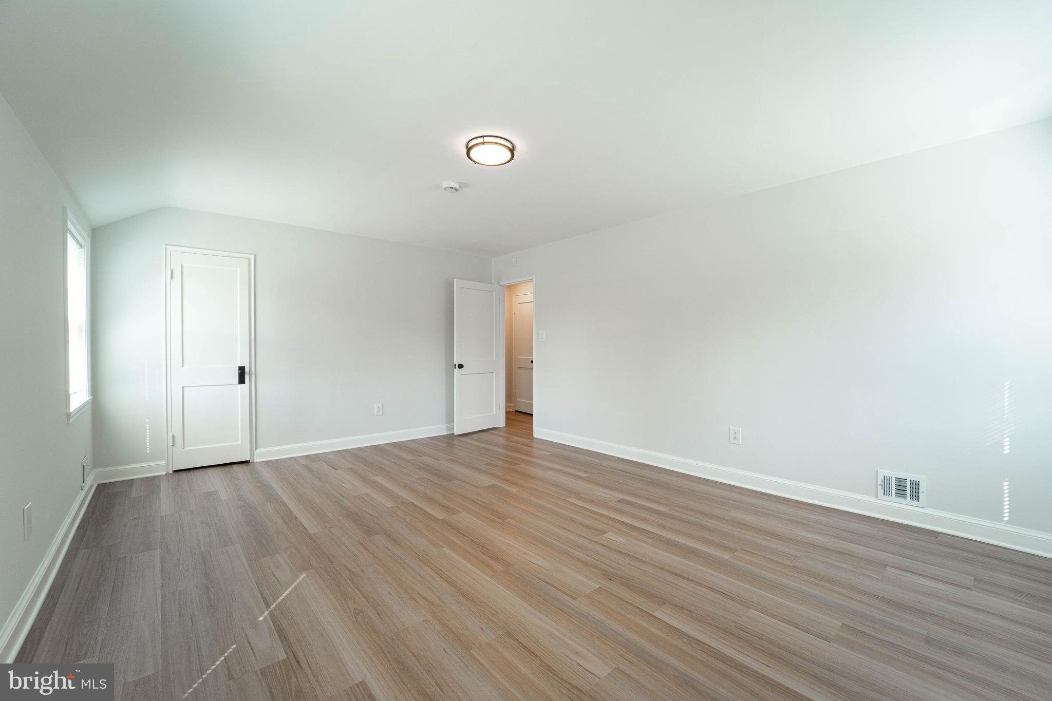 8909 Georgia Avenue Silver Spring, MD 20910 - Photo 47 of 47 a view of an empty room with wooden floor