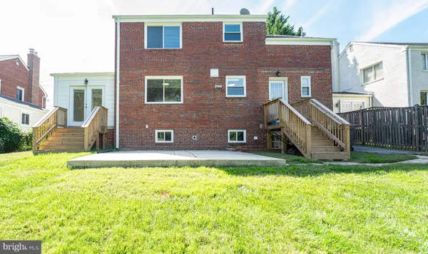 a view of a house with a yard patio and a swimming pool