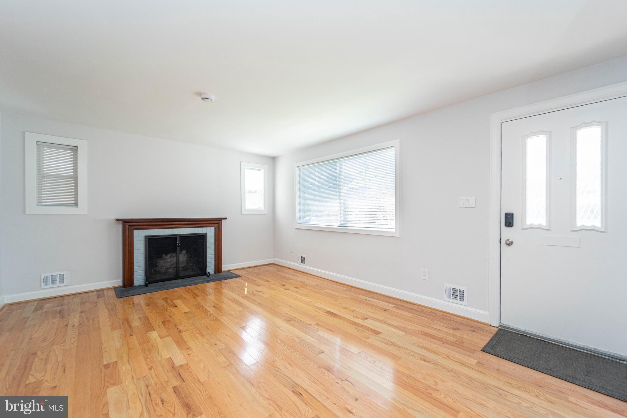 8909 Georgia Avenue Silver Spring, MD 20910 - Photo 8 of 47 a view of empty room with wooden floor and fan