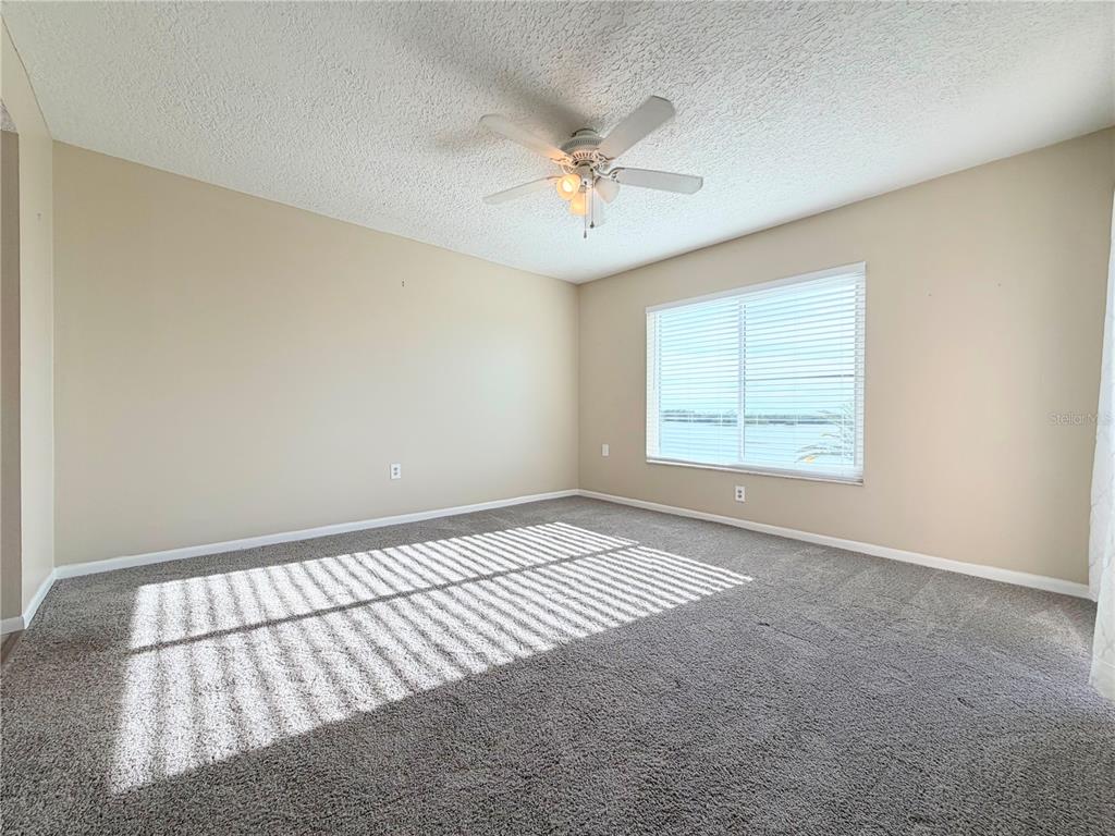 4550 Bay Boulevard, Unit 1224 Port Richey, FL 34668 - Photo 14 of 25 an empty room with windows and fan