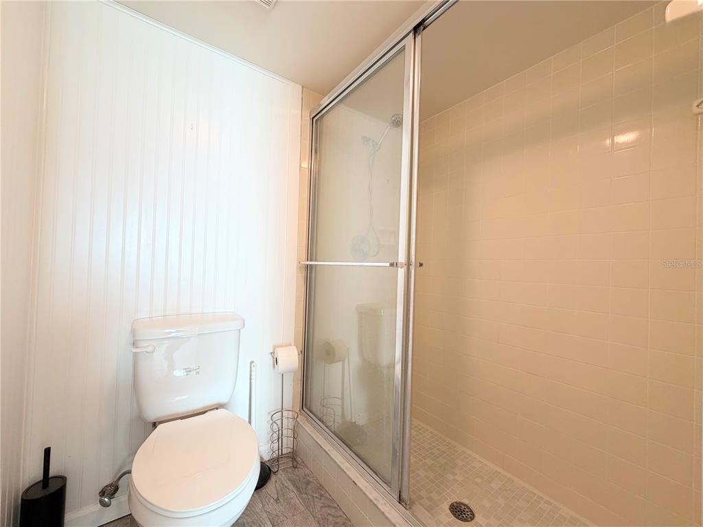 4550 Bay Boulevard, Unit 1224 Port Richey, FL 34668 - Photo 18 of 25 a bathroom with a toilet and a shower