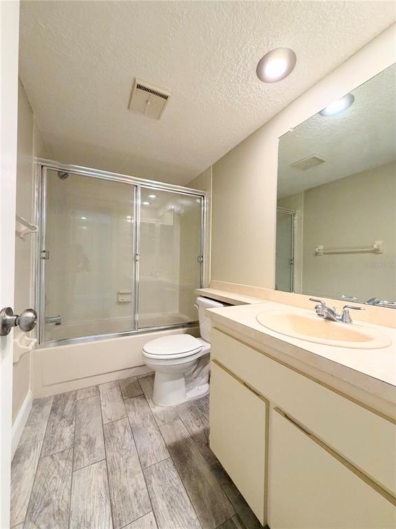 4550 Bay Boulevard, Unit 1224 Port Richey, FL 34668 - Photo 20 of 25 a bathroom with a sink a toilet and a large mirror