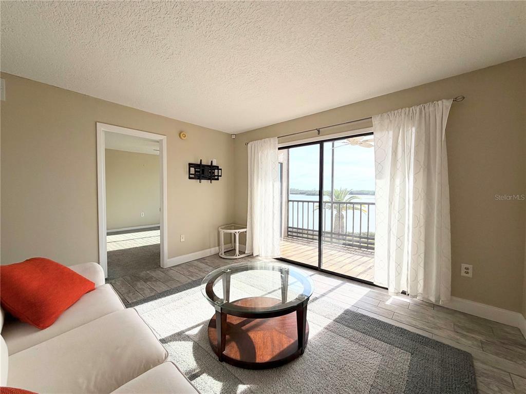 4550 Bay Boulevard, Unit 1224 Port Richey, FL 34668 - Photo 4 of 25 a living room with furniture and a large window