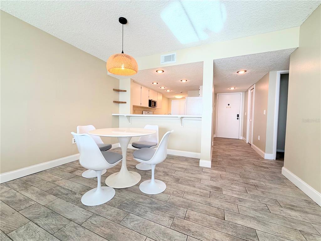 4550 Bay Boulevard, Unit 1224 Port Richey, FL 34668 - Photo 6 of 25 a view of a dining room with furniture and wooden floor