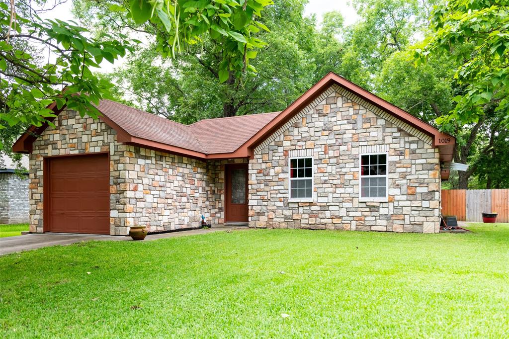1019 Pine Street Bonham, TX 75418 - Photo 1 of 26 a view of a house with a yard