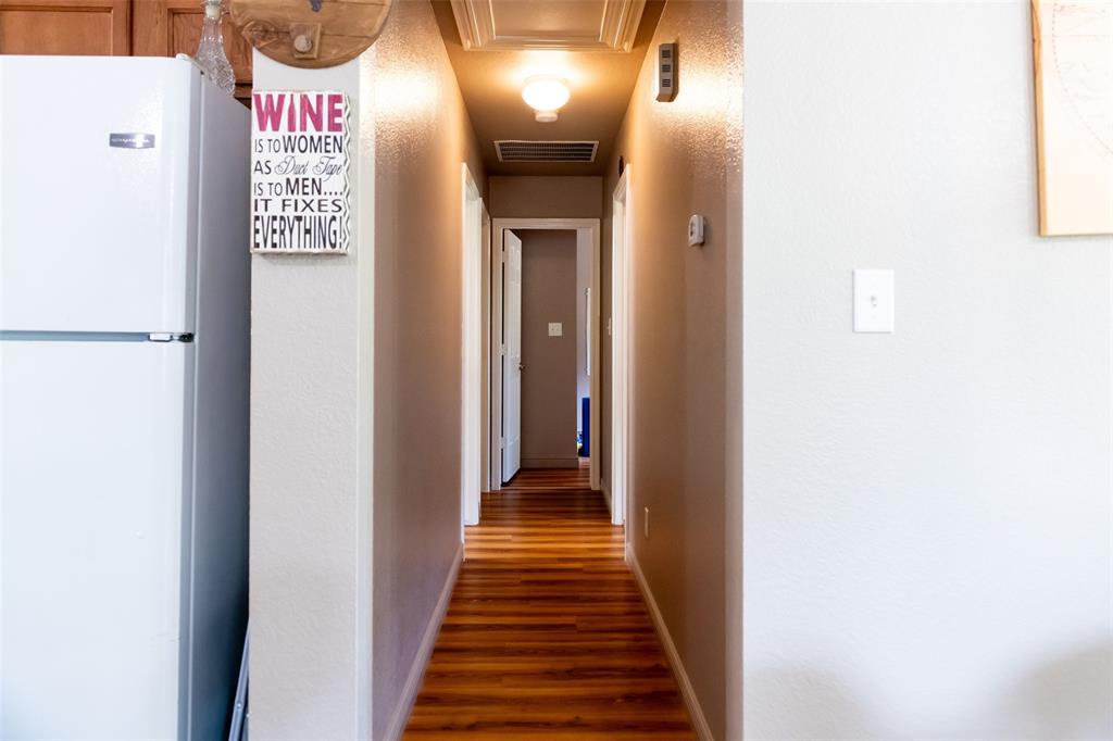 1019 Pine Street Bonham, TX 75418 - Photo 12 of 26 a view of a hallway with wooden floor