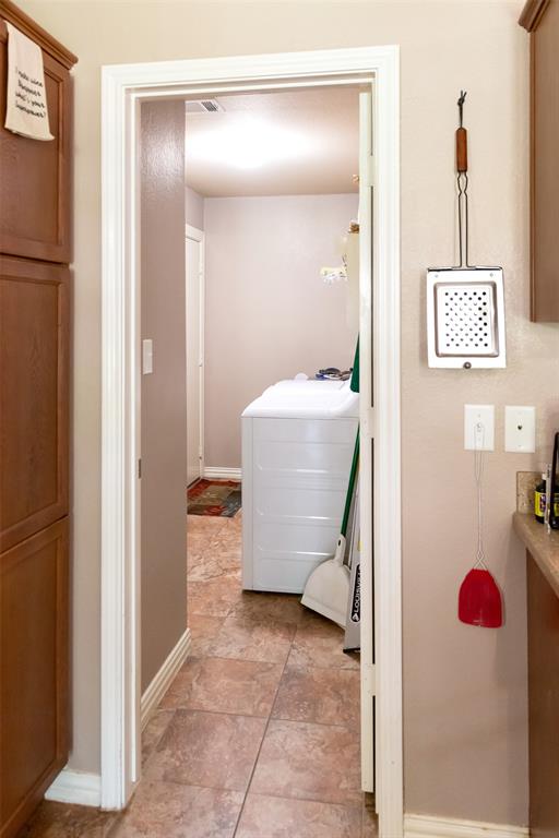 1019 Pine Street Bonham, TX 75418 - Photo 13 of 26 a room with a bench and cabinets