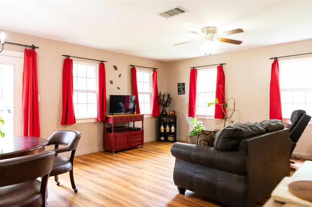 a living room with furniture and a flat screen tv