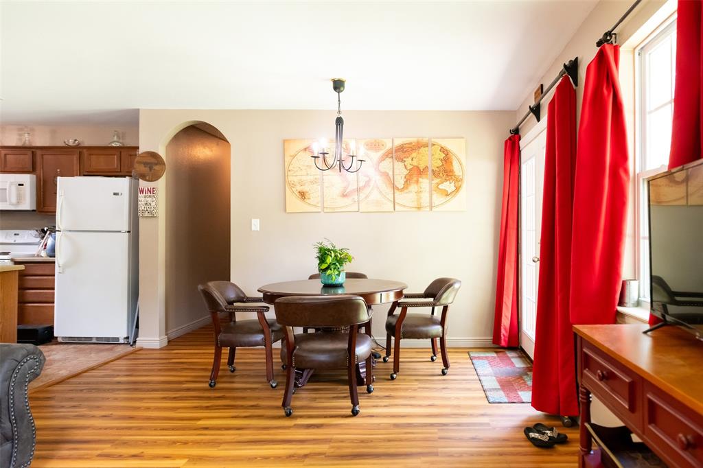 1019 Pine Street Bonham, TX 75418 - Photo 15 of 26 a view of a dining room with furniture and a chandelier