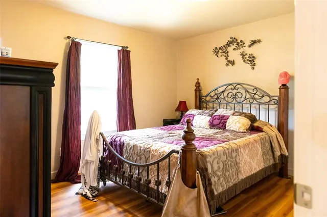 a bedroom with a bed and a painting on the wall