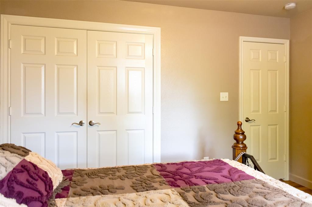 1019 Pine Street Bonham, TX 75418 - Photo 21 of 26 a bedroom with a bed and a window
