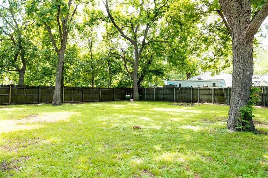 1019 Pine Street Bonham, TX 75418 - Photo 24 of 26 a view of a yard with a large tree