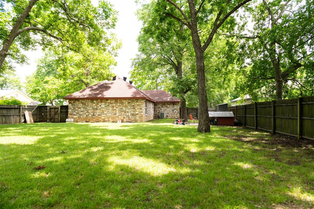 1019 Pine Street Bonham, TX 75418 - Photo 25 of 26 a backyard of a house with table and chairs