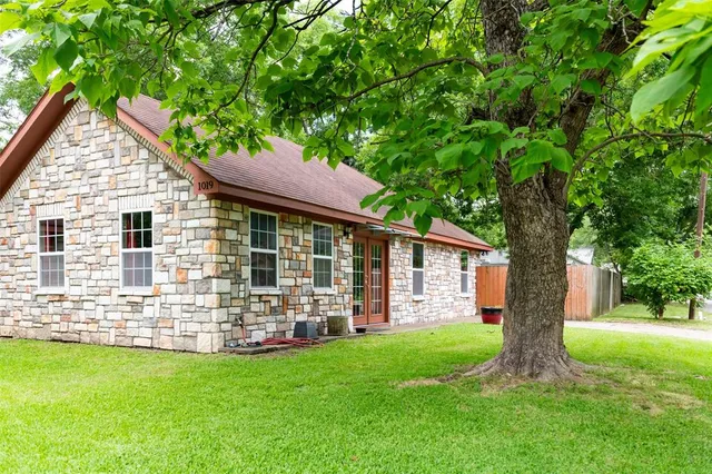 a front view of house with yard and green space