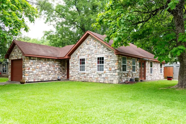 a view of a house with a yard and sitting area
