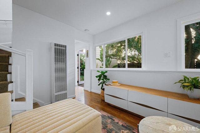 a bedroom with a bed and a potted plant