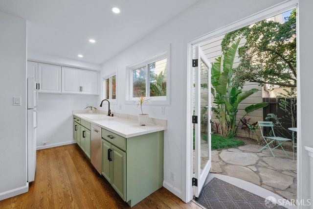 a kitchen with a sink stove and wooden cabinets