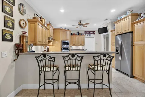 a kitchen with stainless steel appliances granite countertop a stove sink and cabinets