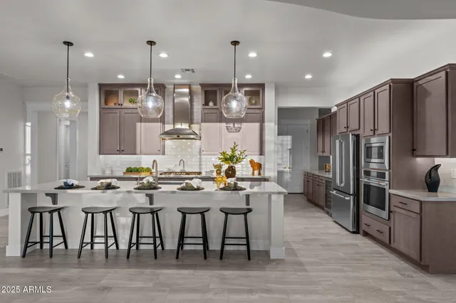 a dining room with furniture large windows and a chandelier