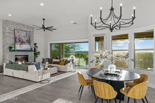 a kitchen with stainless steel appliances granite countertop a sink a stove a refrigerator cabinets and dining table