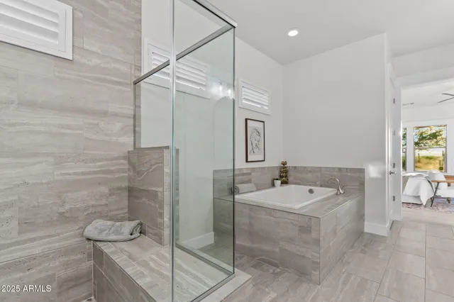 a living room with patio furniture and a garden