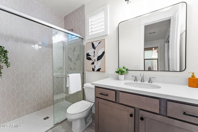 a view of a workspace with furniture and a flat screen tv