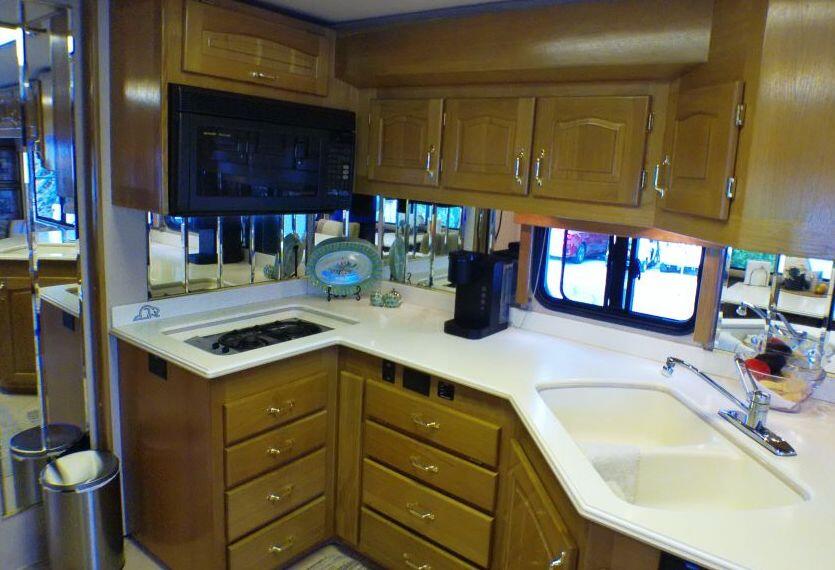 84136 Ave 44, Unit 587 Indio, CA 92203 - Photo 23 of 36 a kitchen with a sink cabinets and a wooden floor