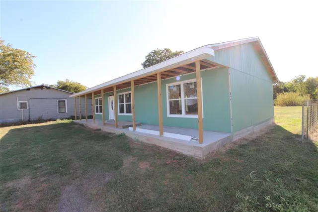 a backyard of a house with wooden fence