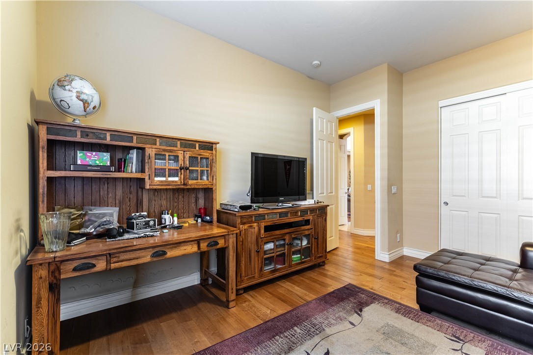 3661 Riley Ann Avenue Las Vegas, NV 89139 - Photo 27 of 42 A well-lit room featuring rich hardwood flooring and a functional study area.