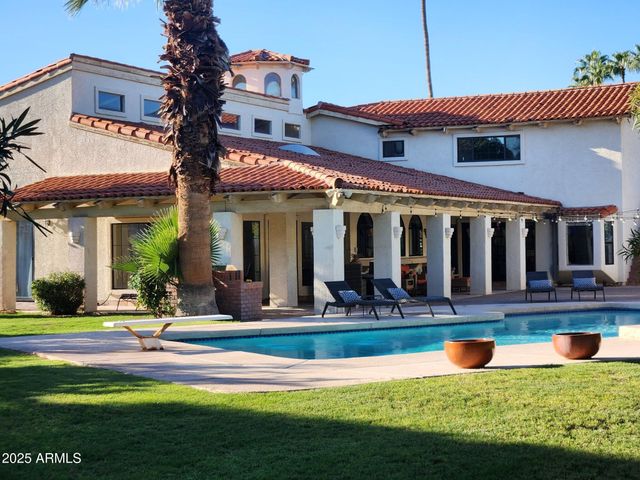 a view of a house with swimming pool and a yard